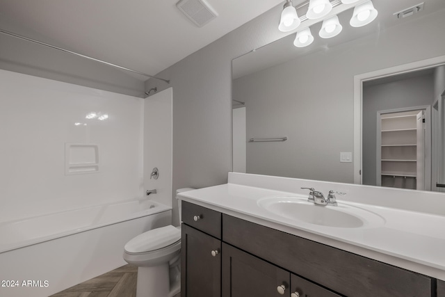 full bathroom featuring parquet flooring, vanity, toilet, and tub / shower combination