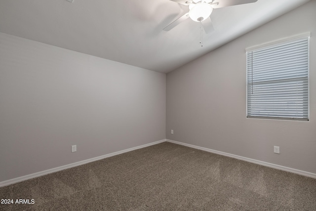 carpeted spare room featuring ceiling fan and lofted ceiling