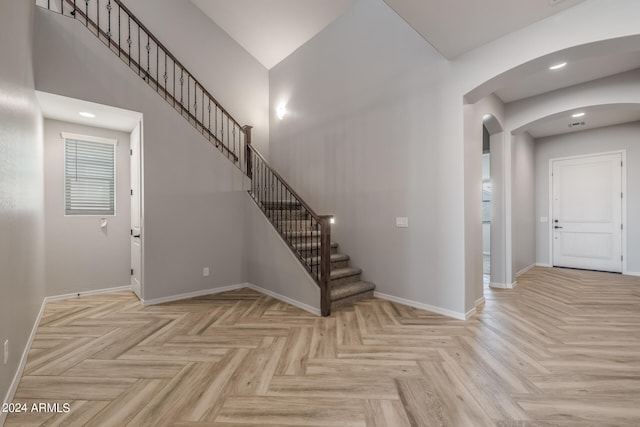 staircase featuring light parquet floors