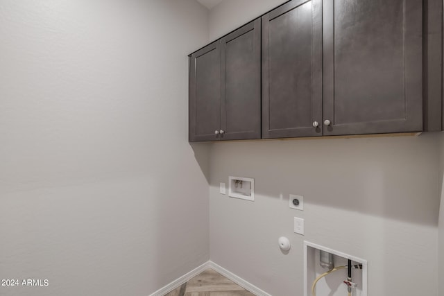 laundry room featuring gas dryer hookup, cabinets, hookup for a washing machine, and electric dryer hookup