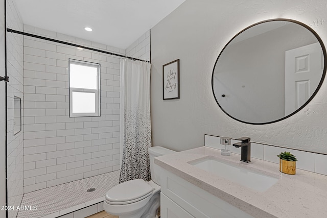 bathroom with vanity, toilet, and walk in shower