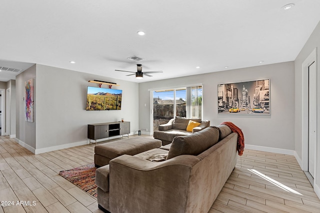 living room featuring ceiling fan and light hardwood / wood-style flooring