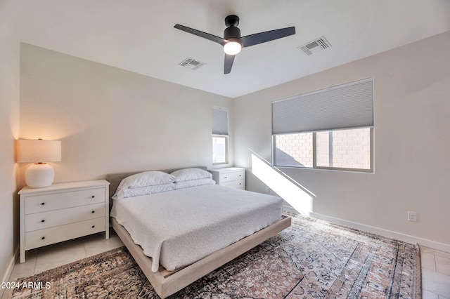 tiled bedroom with ceiling fan