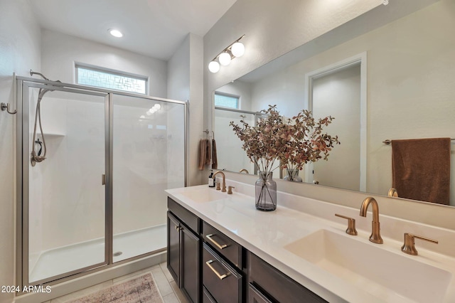 bathroom with vanity, a shower with shower door, and tile patterned flooring