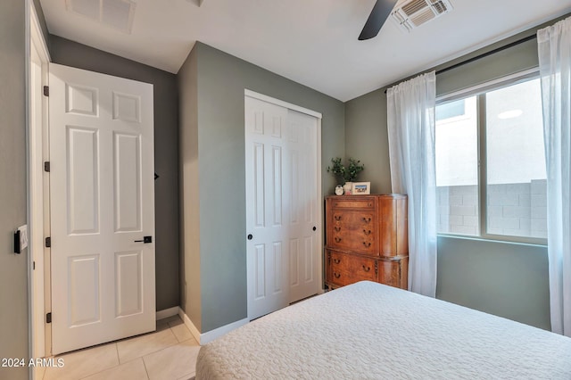 tiled bedroom with a closet and ceiling fan