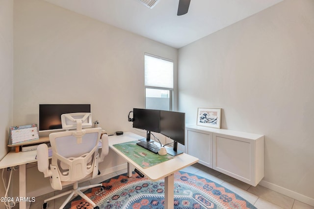 tiled office featuring ceiling fan