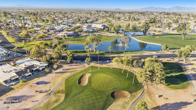 birds eye view of property with a water and mountain view