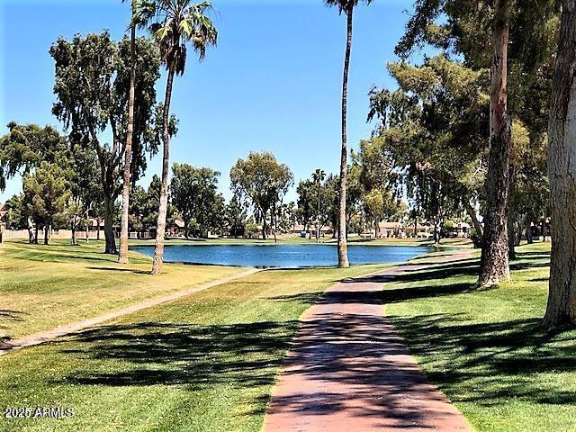 surrounding community featuring a yard and a water view