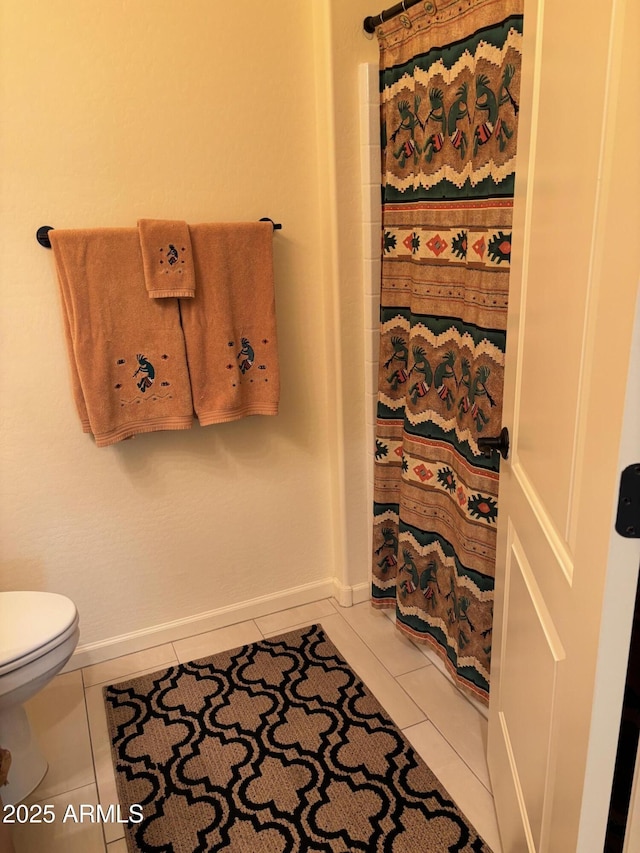 bathroom with tile patterned flooring and toilet