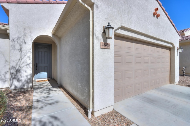 view of exterior entry featuring a garage