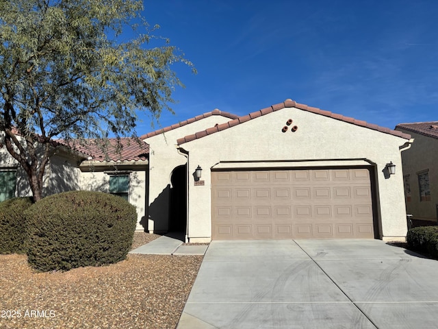 mediterranean / spanish-style home with a garage