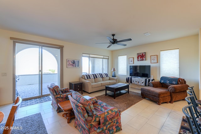 living room featuring ceiling fan and light tile patterned floors