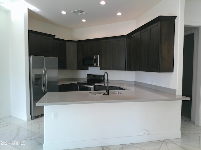 kitchen featuring dark brown cabinets, appliances with stainless steel finishes, sink, and kitchen peninsula