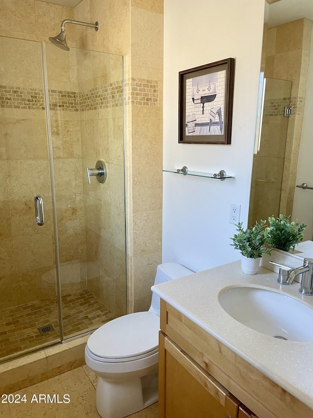 full bathroom with a shower stall, vanity, and toilet