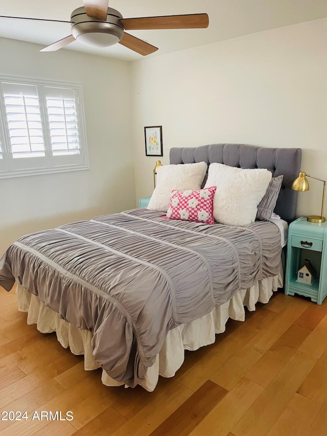 bedroom with a ceiling fan and wood finished floors