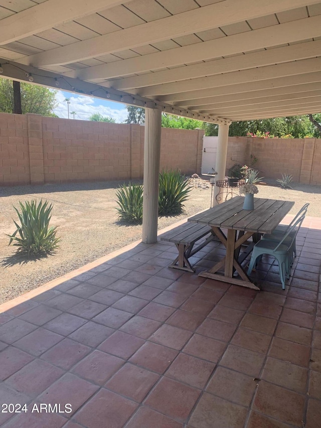 view of patio with a fenced backyard and outdoor dining space