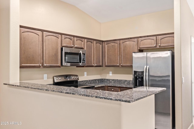 2725 E Mine Creek Rd Unit 2146, Phoenix, AZ 85024 - kitchen featuring stainless steel appliances, a peninsula, dark stone counters, lofted ceiling, and dark brown cabinetry
