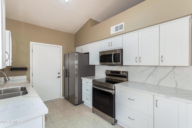 kitchen with a sink, stainless steel appliances, visible vents, and white cabinetry