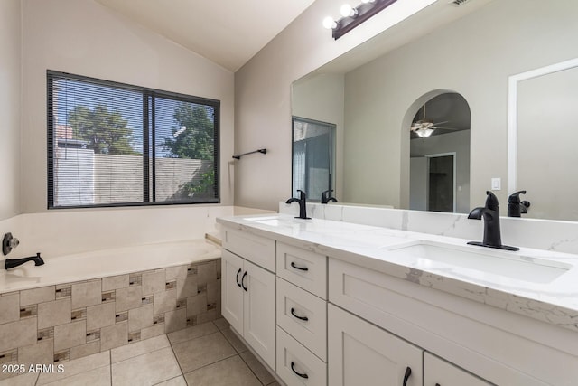 bathroom featuring tile patterned flooring, lofted ceiling, a ceiling fan, and a sink