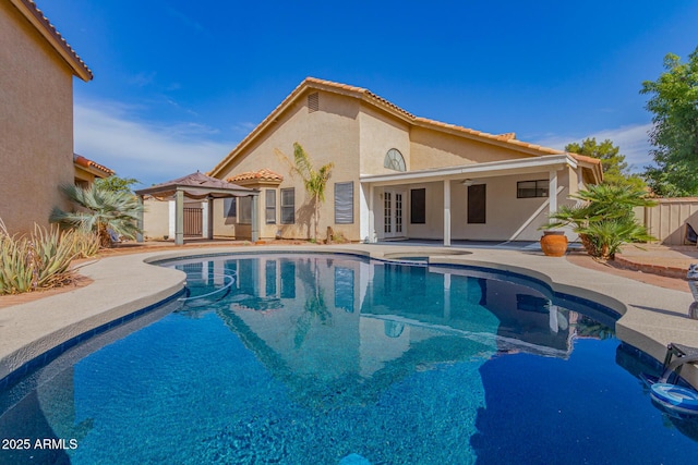 view of pool featuring a ceiling fan, a patio, fence, french doors, and a fenced in pool