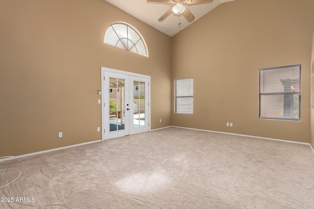 unfurnished room with high vaulted ceiling, carpet flooring, french doors, and ceiling fan