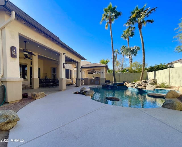 view of swimming pool featuring an in ground hot tub, an outdoor kitchen, ceiling fan, and a patio area