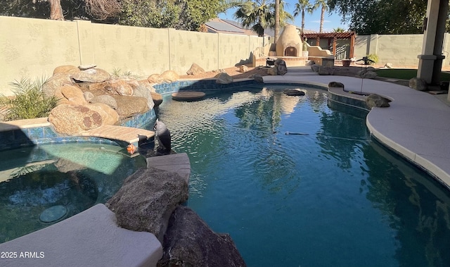 view of swimming pool with exterior fireplace