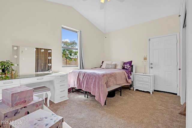 bedroom featuring light colored carpet, vaulted ceiling, and a ceiling fan