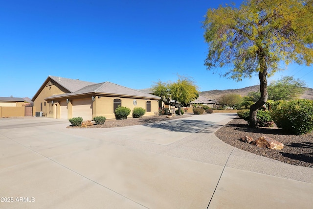 view of front facade featuring a garage and a mountain view