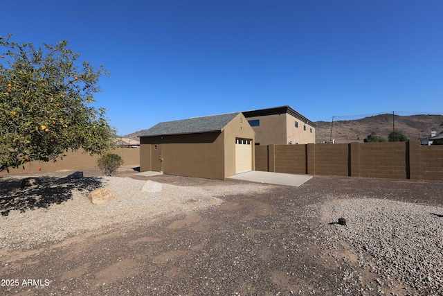 view of yard with a garage and an outbuilding