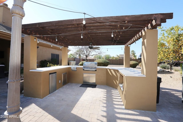 view of patio / terrace with area for grilling, a pergola, and an outdoor kitchen