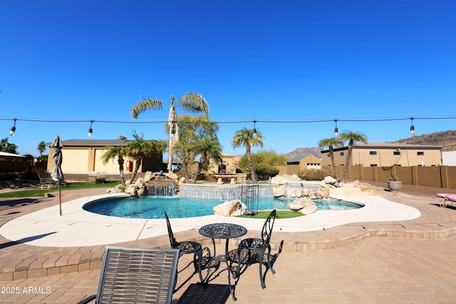 view of pool featuring pool water feature and a patio area