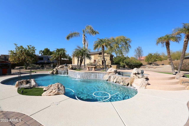 view of swimming pool featuring an in ground hot tub, pool water feature, and a patio area