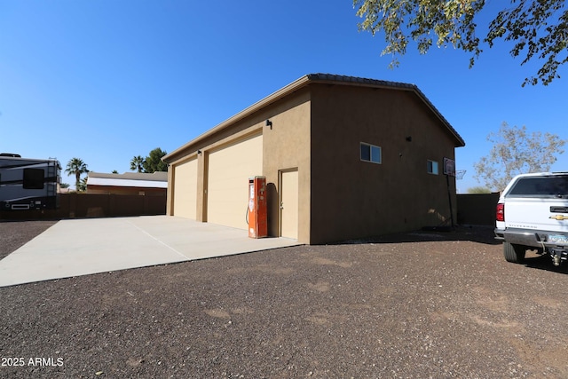 view of side of home with an outbuilding and a garage