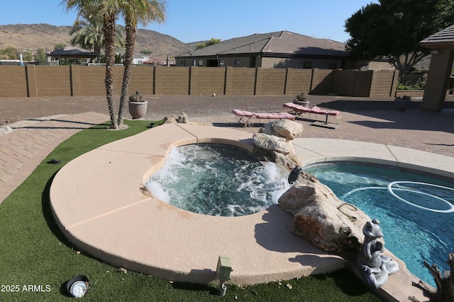 view of swimming pool with an in ground hot tub and a mountain view