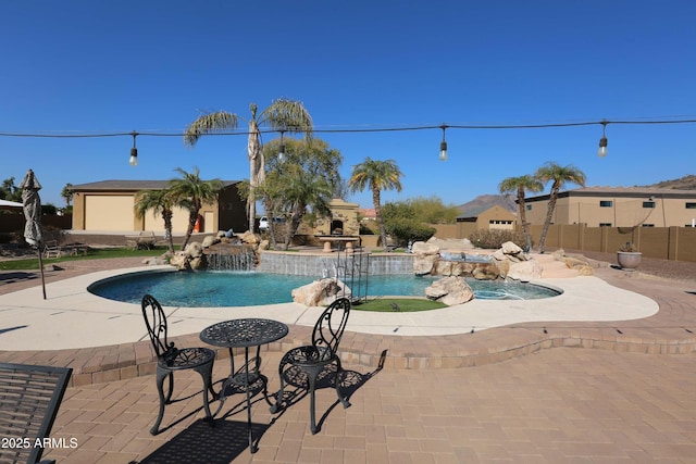 view of pool with pool water feature and a patio area