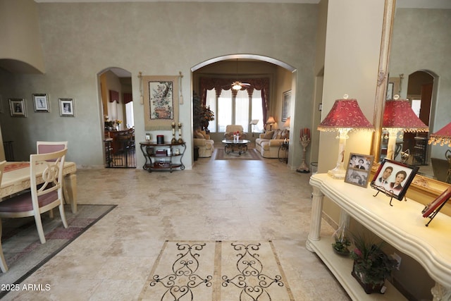 entrance foyer with a notable chandelier and a towering ceiling