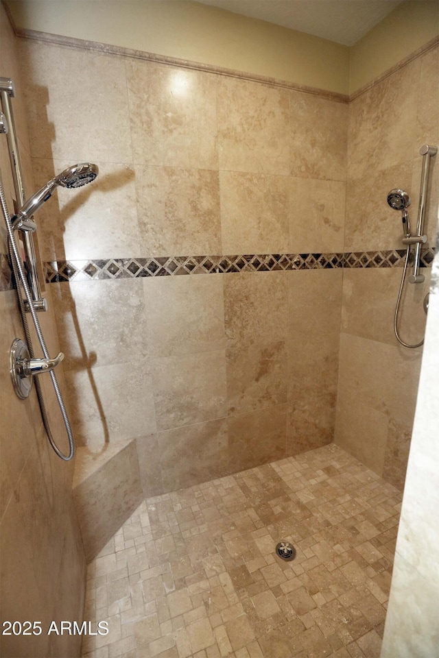 bathroom featuring a tile shower