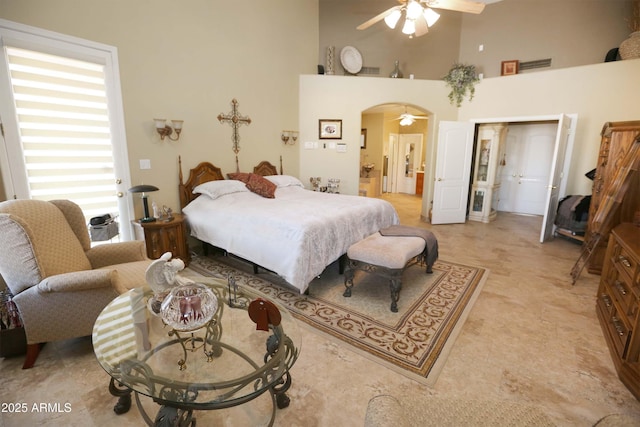 bedroom featuring a high ceiling and ceiling fan