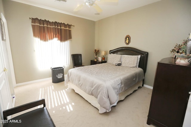 bedroom with light carpet, crown molding, and ceiling fan