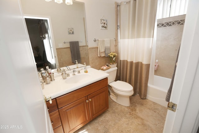 full bathroom featuring shower / bathtub combination with curtain, vanity, tile walls, and toilet