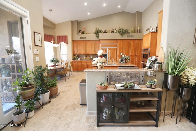 kitchen featuring high vaulted ceiling, paneled fridge, kitchen peninsula, and sink