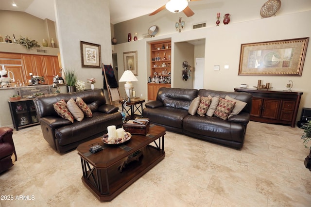 living room with ceiling fan and high vaulted ceiling