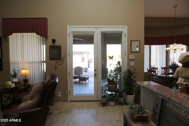 doorway with an inviting chandelier and french doors