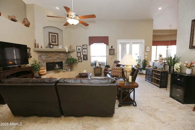 living room featuring a fireplace and ceiling fan