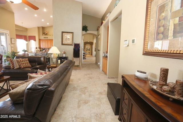 living room featuring high vaulted ceiling and ceiling fan