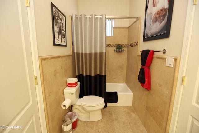 bathroom featuring shower / bath combo with shower curtain, toilet, tile patterned flooring, and tile walls