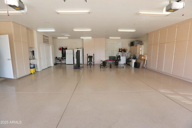 garage featuring a garage door opener, fridge, and white refrigerator