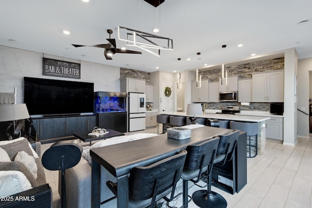 226 E Markwood Dr, Chandler, AZ 85286 - kitchen featuring appliances with stainless steel finishes, decorative backsplash, an island with sink, light countertops, and recessed lighting