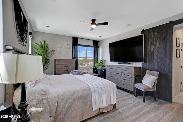 226 E Markwood Dr, Chandler, AZ 85286 - bedroom with light wood-type flooring, a barn door, and ceiling fan
